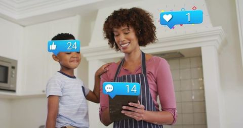 Mother and son sharing tablet in bright kitchen with social media notification overlays