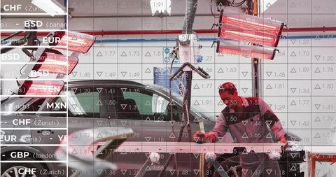 Automotive technician repairing bumper using infrared curing lamps in body shop