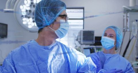 Placing Gloved Hand on Colleague's Arm, Surgical Team Exchanging Look in Operating Room