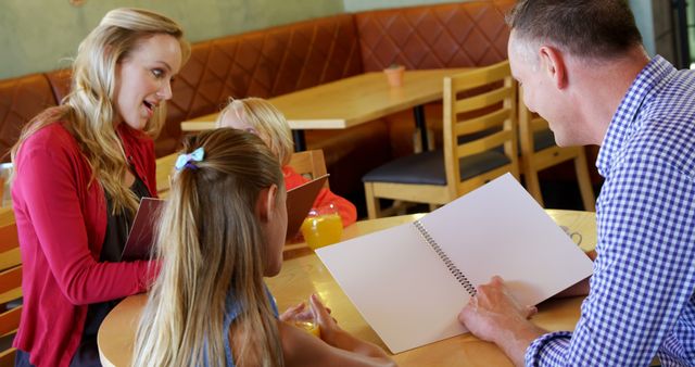 Happy Family Ordering Food Together in Restaurant - Download Free Stock Images Pikwizard.com