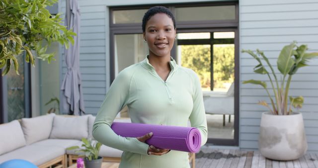 Confident Woman Holding Yoga Mat Outdoors in Modern Backyard - Download Free Stock Images Pikwizard.com