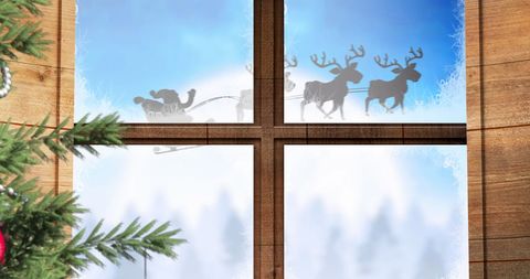 Santa and Reindeer Silhouette Through Winter Window