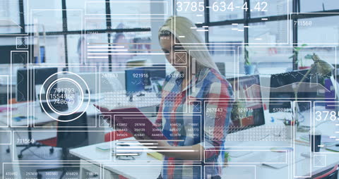 Businesswoman Analyzing Data with Digital Interfaces in Modern Office