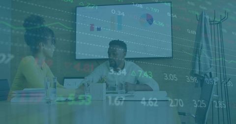 Diverse Coworkers Discussing Financial Strategy in Office