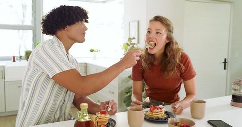 Couple Sharing Pancake Breakfast at Modern Kitchen Island