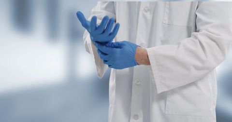 Doctor wearing protective gloves in hospital setting