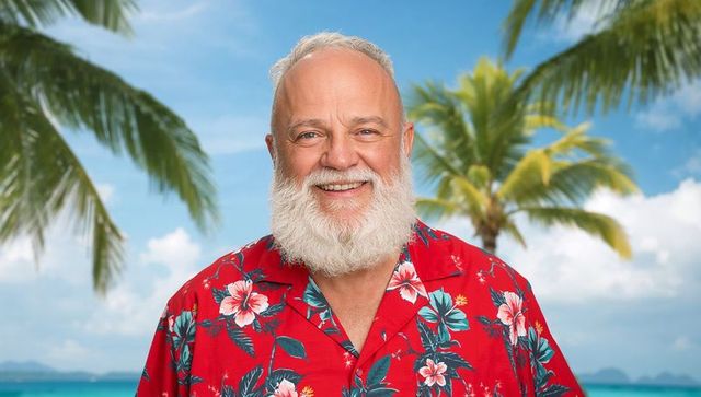 Smiling elderly man in hawaiian shirt enjoying tropical beach