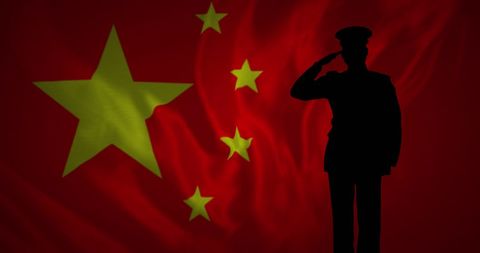 Silhouette of Soldier Saluting Against China Flag Background