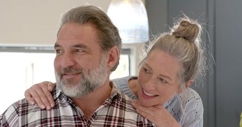 Senior Couple Sharing Warm Moment in Modern Kitchen Setting