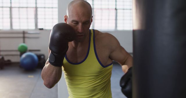 Man Punching Boxing Bag in Gym Training for Fitness - Download Free Stock Images Pikwizard.com