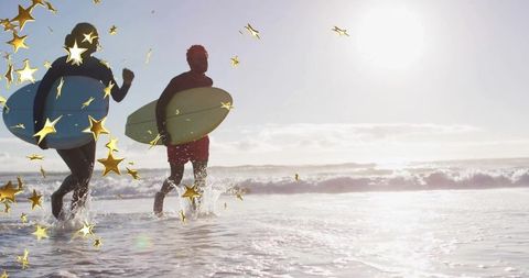 Surf Enthusiasts Running on Sunny Beach with Surfboards