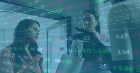 Diverse Team Analyzing Financial Data with Stock Trades Display