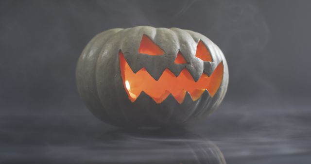 Smoky Halloween Jack-o'-Lantern Glowing in Darkness - Download Free Stock Photos Pikwizard.com