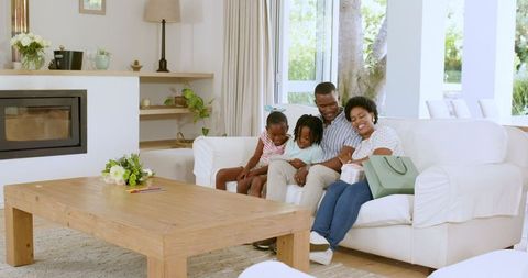 Family Relaxing on Sofa Taking Selfie in Bright Living Room