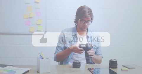 Photographer inspecting dslr camera at creative workspace