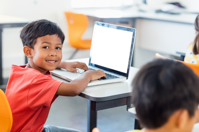 Transparent Schoolboy Smiling While Using Laptop in Classroom - Download Free Stock Videos Pikwizard.com