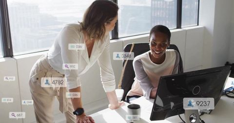 Colleagues Collaborating on Data in Modern Office Environment