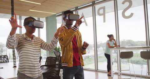 Creative Colleagues Experiencing Virtual Reality in Modern Office