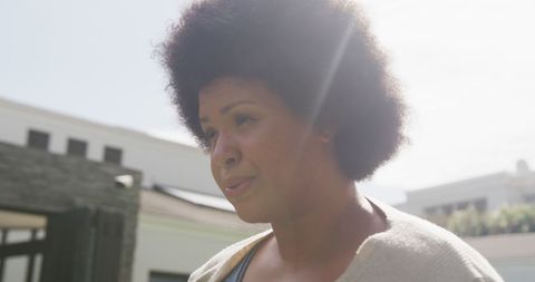 Plus size woman using inhaler outdoors for asthma relief