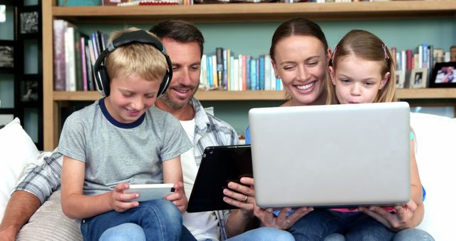 Happy Family Using Technology Together on Sofa - Download Free Stock Images Pikwizard.com