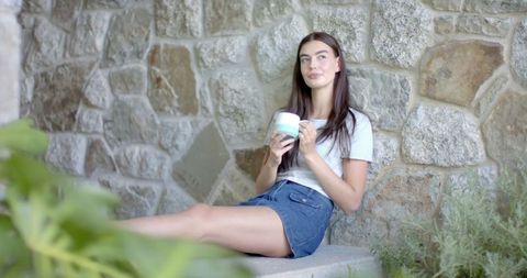 Young Woman Enjoying Coffee Outdoors