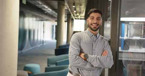Confident Professional Man in Modern Office Corridor