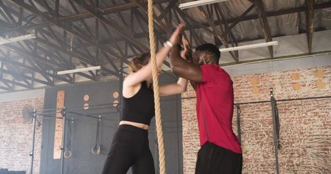 Fitness partners collaborating in industrial gym environment