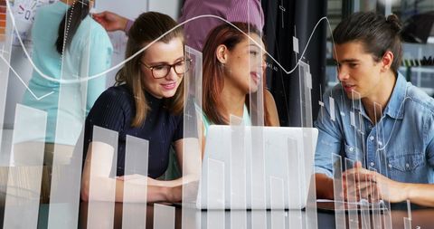 Diverse team analyzing financial data on laptop