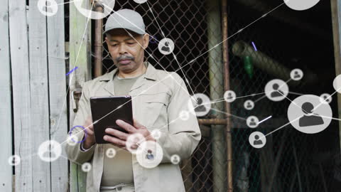 Senior Man Using Tablet with Digital Network Icons Overlay