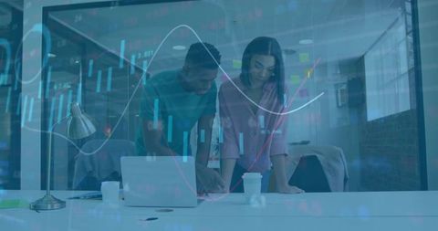 Business team analyzing data charts in modern office environment