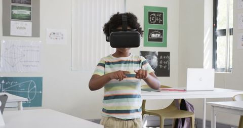 Schoolboy using vr headset in classroom exploring virtual geometry and interactive learning