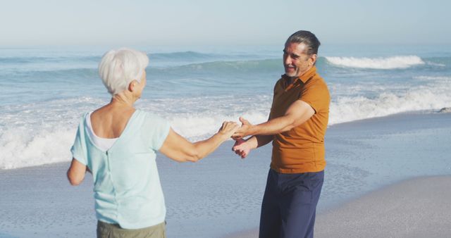 Happy senior caucasian couple dancing on beach. Senior lifestyle, realxation, nature, free time and vacation.