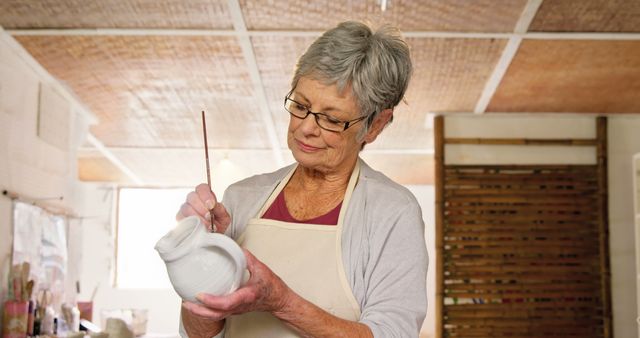 Senior Woman Painting Ceramic Pot in Art Studio - Download Free Stock Images Pikwizard.com