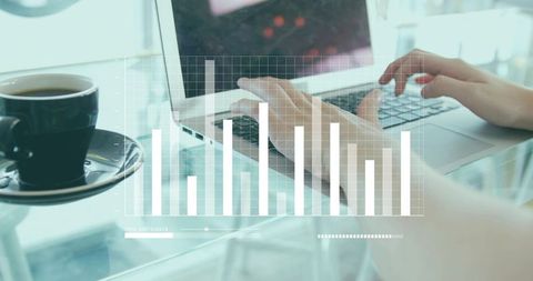 Typing hands on laptop tracking bar chart analytics in bright modern clean cafe workspace
