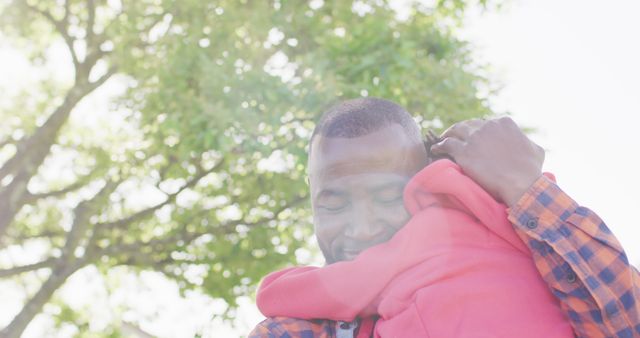 Loving Father Hugging Child Under Tree on Sunny Day - Download Free Stock Images Pikwizard.com