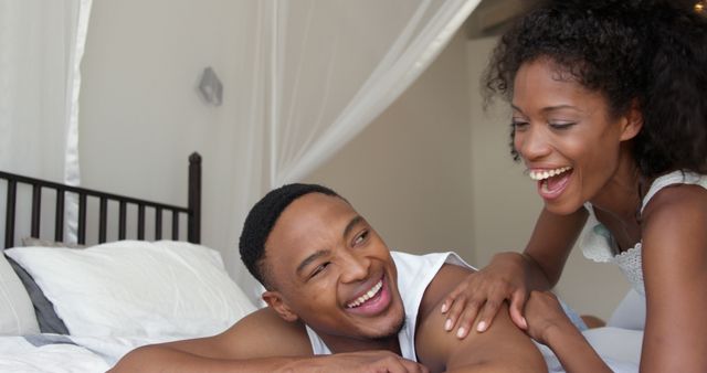 Happy Couple Laughing and Relaxing On Bed - Download Free Stock Images Pikwizard.com