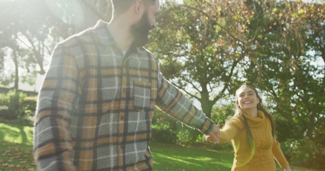 Joyful Couple in Autumn Park Holding Hands and Smiling - Download Free Stock Images Pikwizard.com