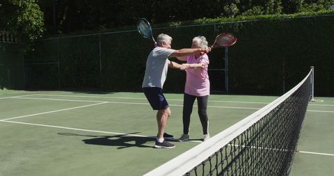 Senior Couple Laughing and Hugging on Outdoor Tennis Court - Download Free Stock Images Pikwizard.com