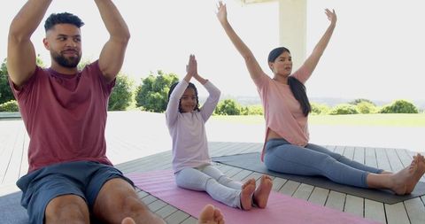 Family yoga session outdoors embodying wellness and harmony