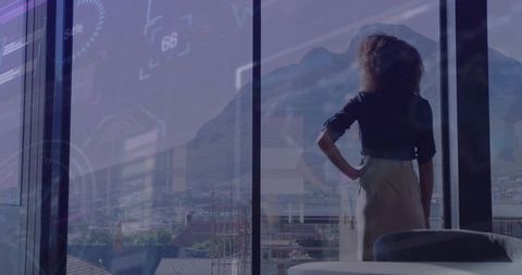 Businesswoman Overlooking Cityscape with Digital Data Overlay