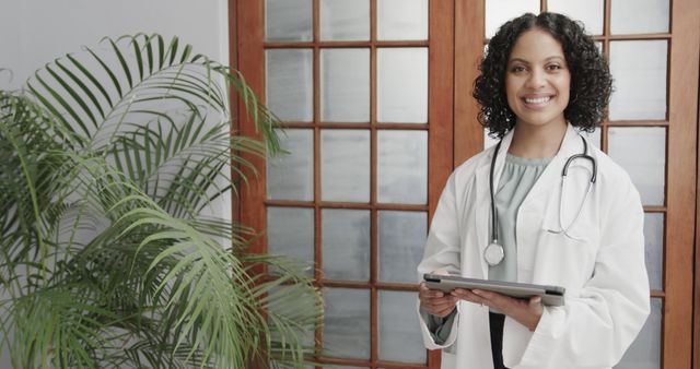 Smiling Female Doctor with Tablet Standing in Office - Download Free Stock Images Pikwizard.com