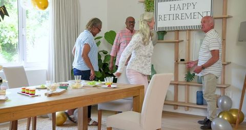 Senior friends celebrating retirement party at home