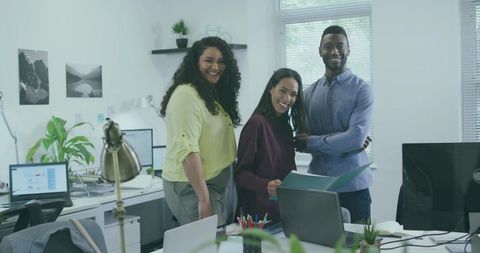 Smiling Coworkers in Modern Office Environment Collaborating on Project