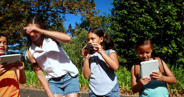 Happy Children Exploring Outdoors with Technology on a Sunny Day - Download Free Stock Images Pikwizard.com