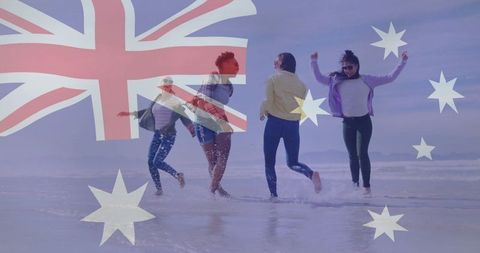 Friends splashing water at beach blended with australian flag