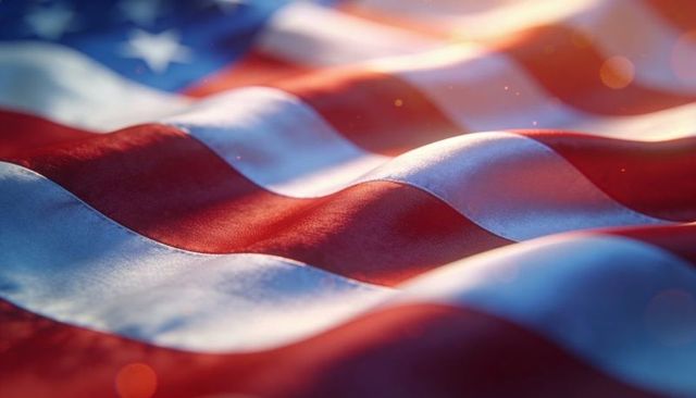 Waving united states flag close-up in warm golden sunlight with stitched fabric texture