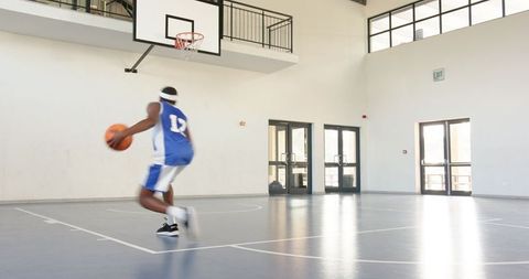 Inspiring Basketball Player Practicing for a Slam Dunk