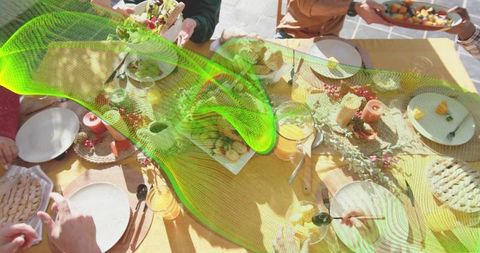 Sunlit Alfresco Gathering Passing Dishes on Wooden Table with Green Glitch