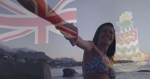 Woman wading by rocky shoreline during romantic sunset