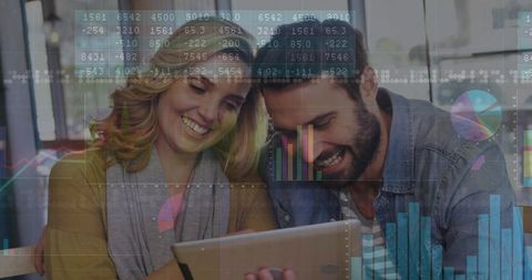 Cheerful Couple Collaborating with Digital Financial Data